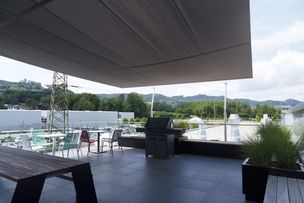 Blick unter dem Trapez-Sonnensegel von der Dachterrasse ins Freie bei TORTEC Brandschutztor GmbH – beschattet, aber offen.